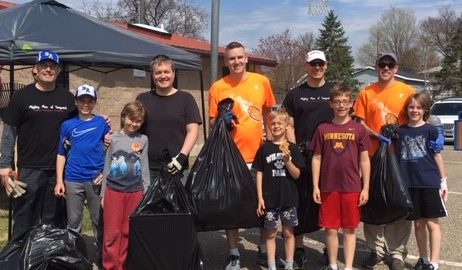 Group poses with litter collected during Earth Day Cleanup
